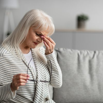 Tired mature woman rubbing dry irritated eyes